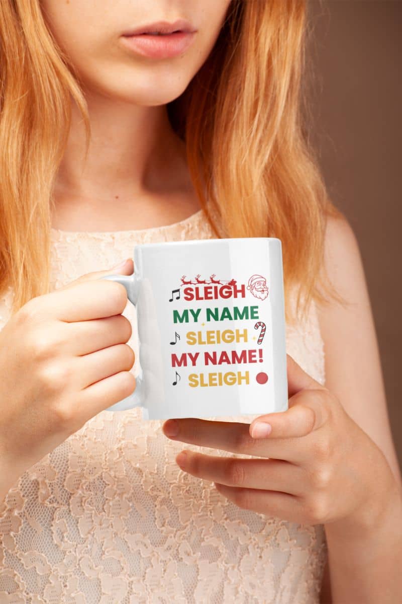 christmas gift mug for coworkers with a person holding a mug with 'Sleigh My Name, Sleigh My Name' text design.