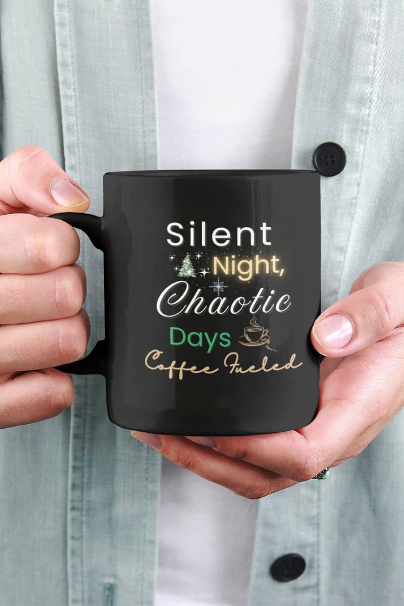 coffee lover christmas gift with a person holding a black mug with text 'Silent Night, Chaotic Days, Coffee Fueled', wearing a light gray shirt.