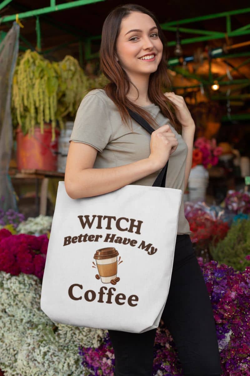 coffee lover tote bag with a woman carrying a tote bag featuring the text 'Witch Better Have My Coffee' at an outdoor market.