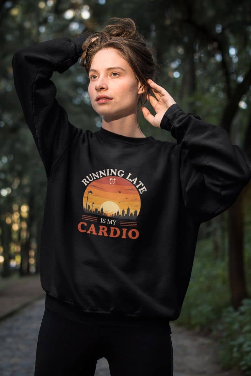 comfy everyday sweatshirt with a person wearing a black sweatshirt with text 'Running Late Is My Cardio' in a forest setting