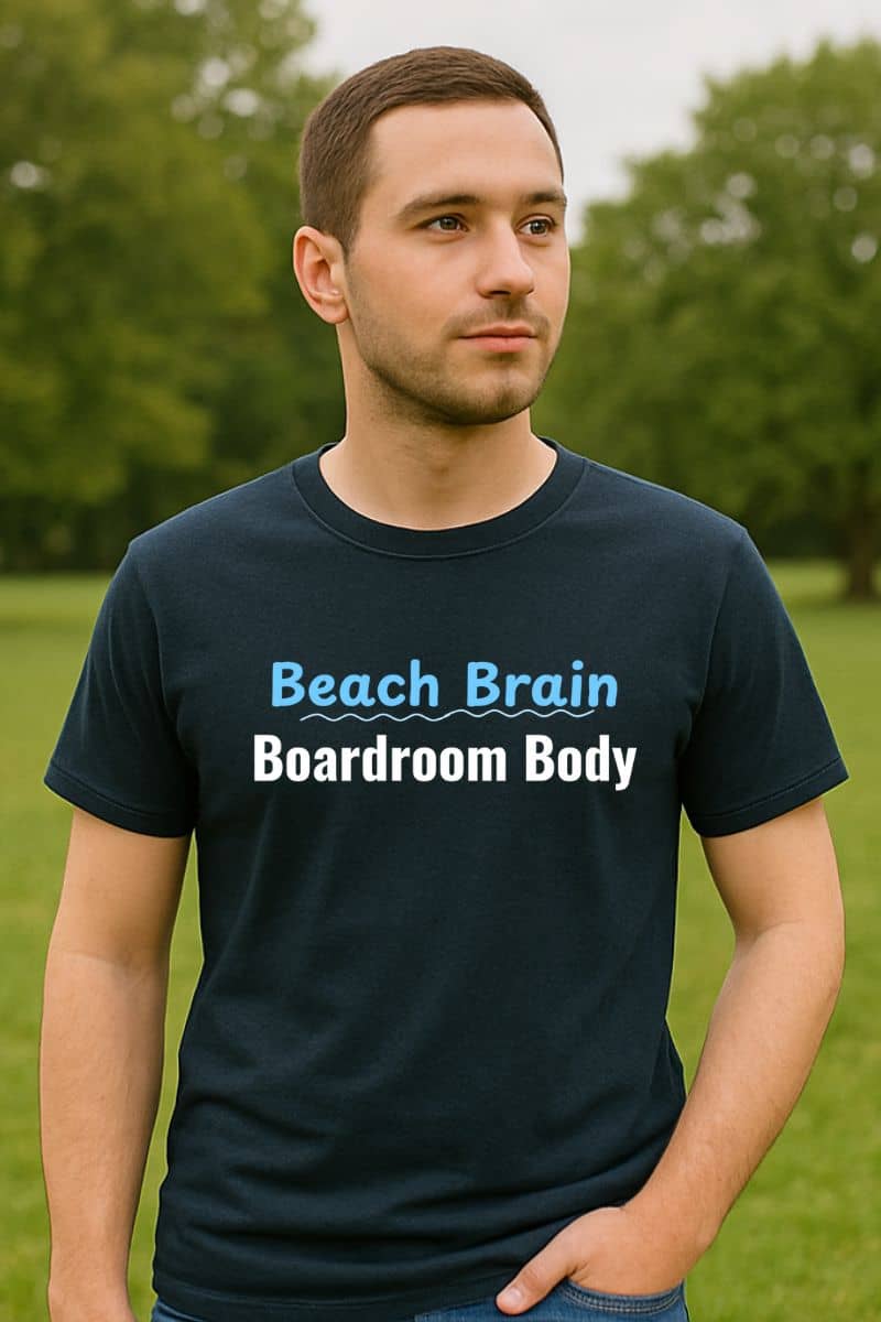 corporate sarcasm tee with a man wearing a black t-shirt with 'Beach Brain Boardroom Body' text in an outdoor setting