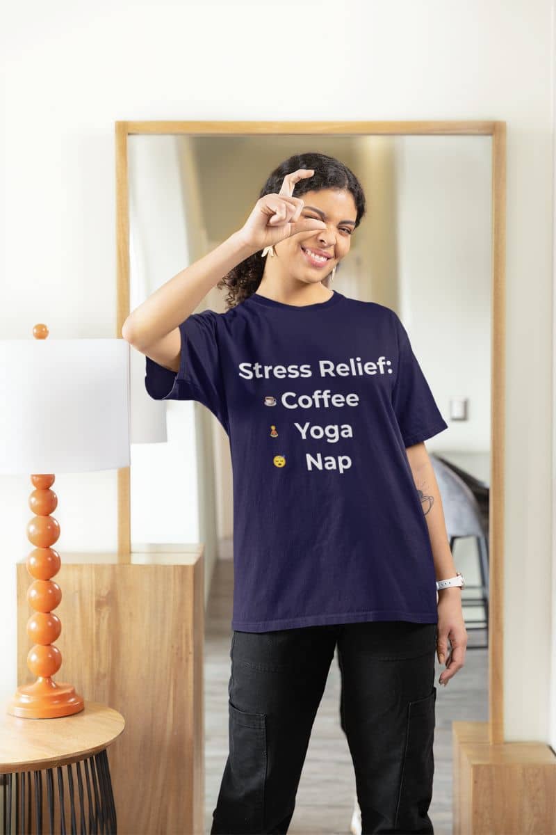 cozy funny shirt for women with a person wearing a purple t-shirt with 'Stress Relief: Coffee Yoga Nap' text in a room.