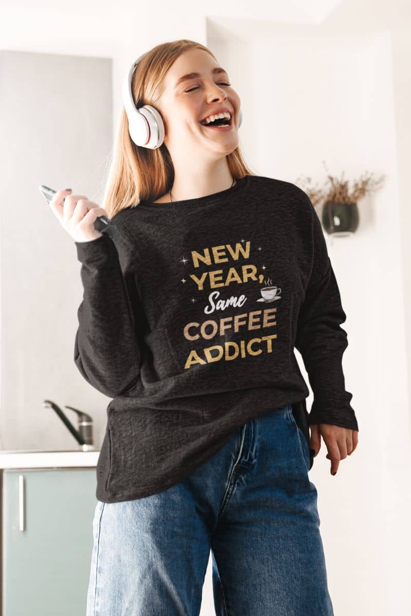 cozy holiday sweatshirt with a girl in a black sweatshirt featuring the text 'New Year, Same Coffee Addict'