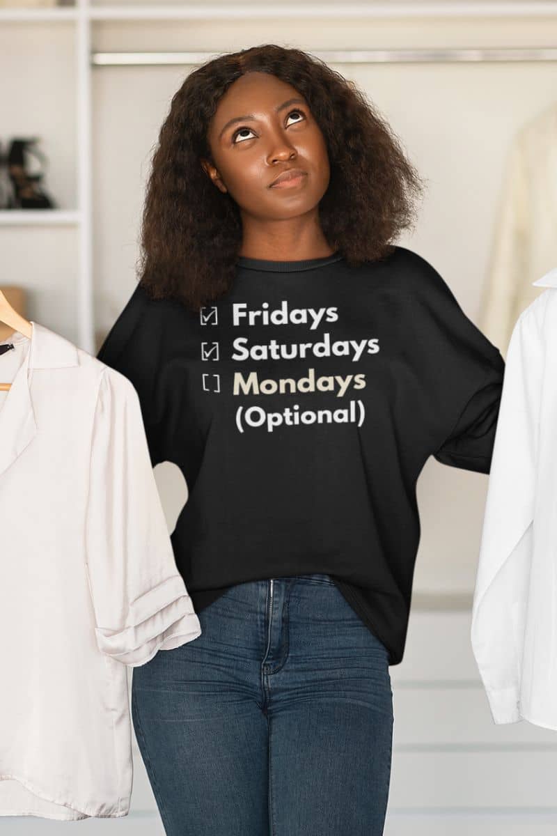 cozy office humor sweatshirt with a person wearing a black t-shirt with text 'Fridays and Saturdays, Mondays (Optional)' in a clothing store