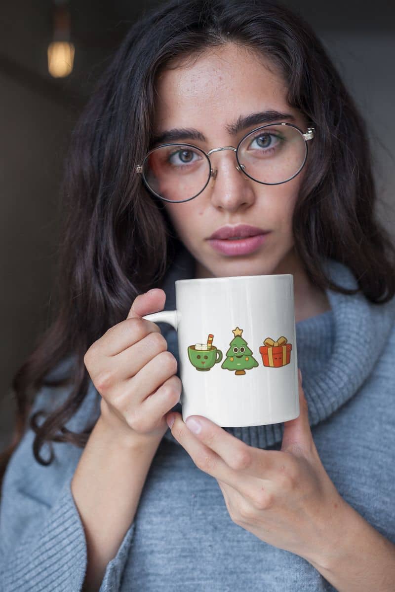 cozy winter coffee mug with a woman holding a mug with cartoon designs on a neutral background