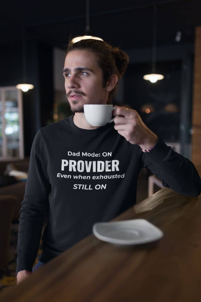 dad sweatshirt with a man wearing a sweatshirt with text 'Dad Mode: On. Provider. Even when exhausted. Still on'