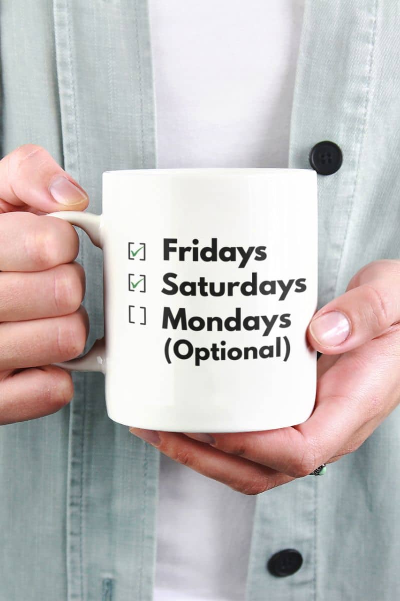 desk humor mug with a person holding a mug with text 'Fridays, Saturdays, Mondays (Optional)'