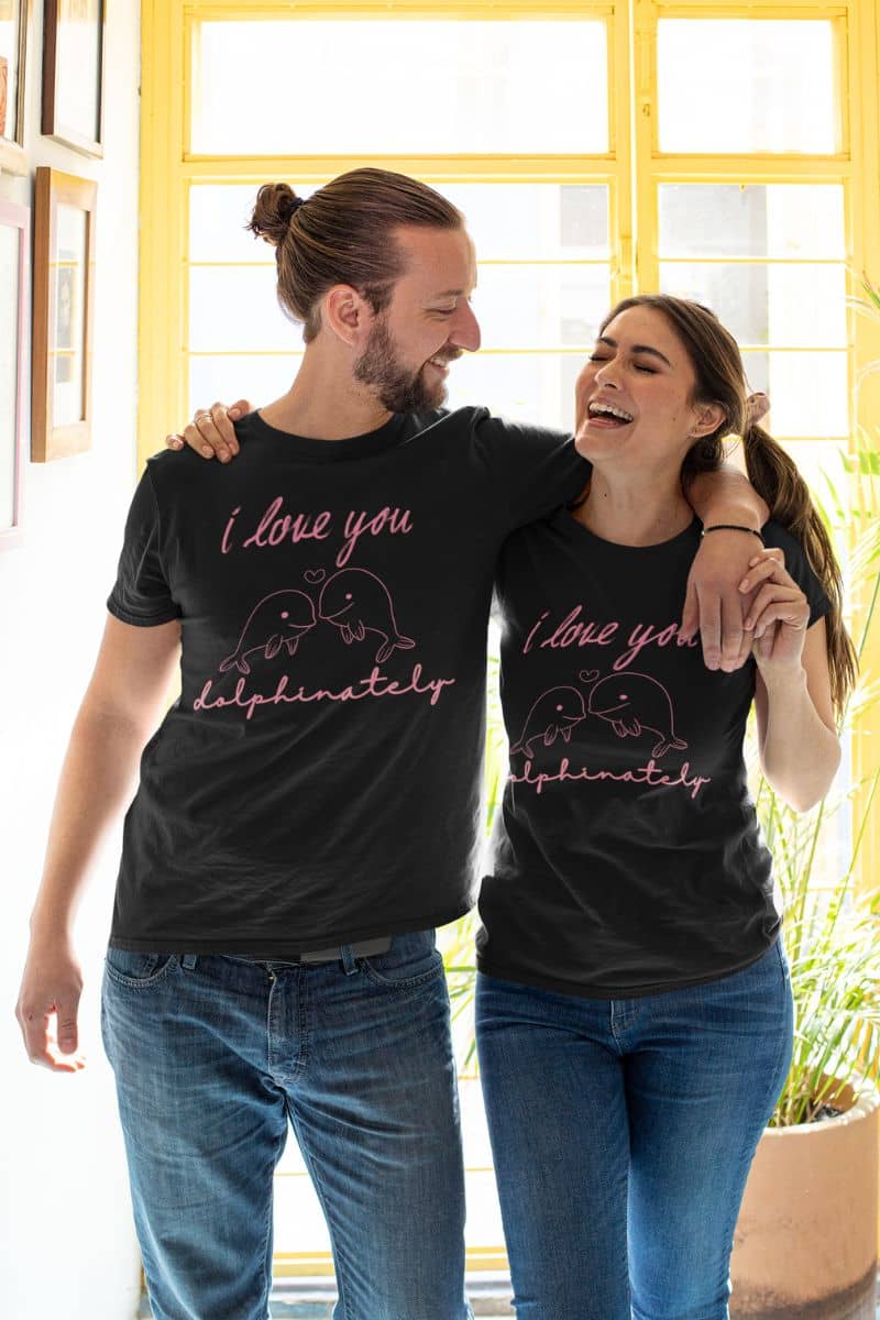 dolphinately love tee with two people wearing matching black t-shirts with a humorous text 'I love you dolphinately', standing close together.