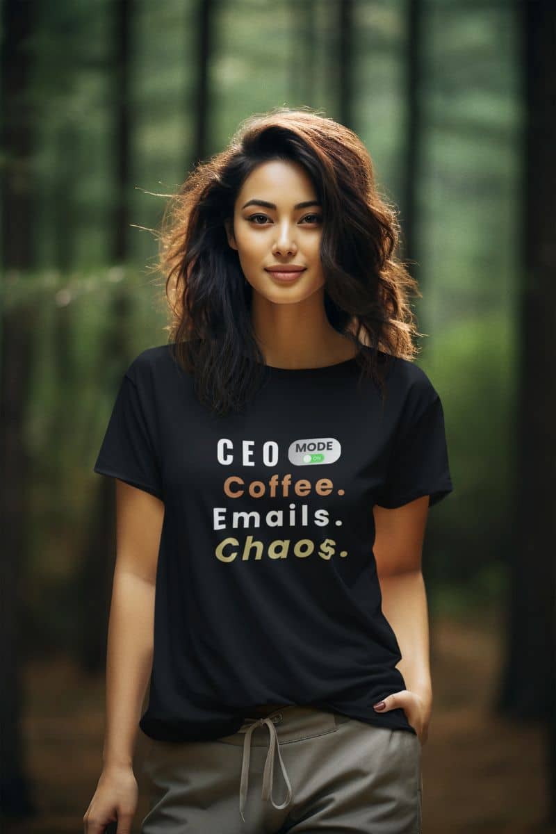 entrepreneur gift idea with a girl wearing a black t-shirt with text 'CEO Mode: Coffee. Emails. Chaos.', in the forest