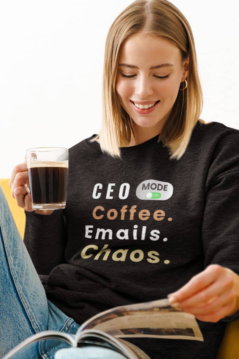 A entrepreneur sweater with a woman in a black sweatshirt with text 'CEO Mode: Coffee. Emails. Chaos.'