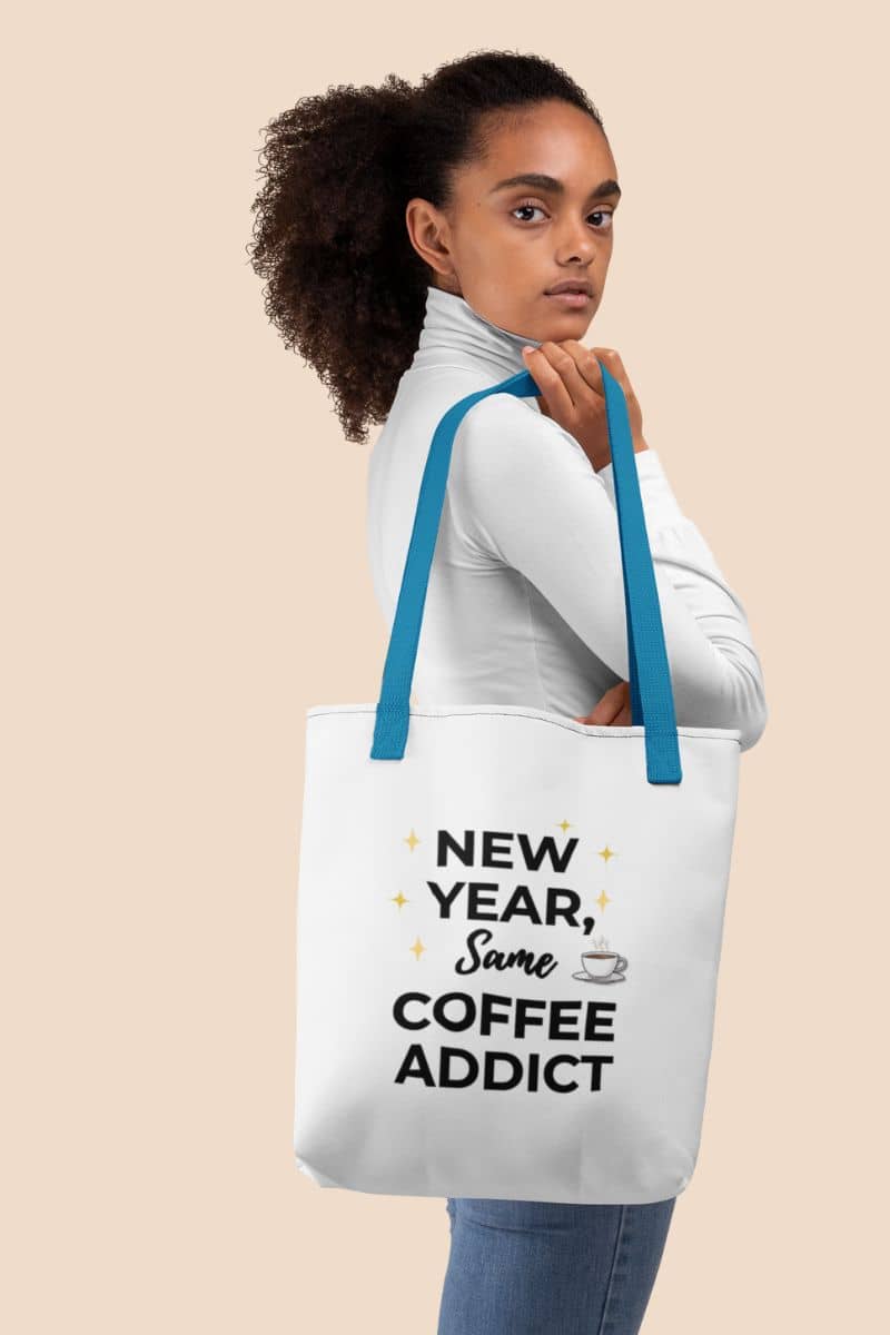 Everyday canvas tote carried by a young Black girl featuring the text ‘New Year, Same Coffee Addict’.