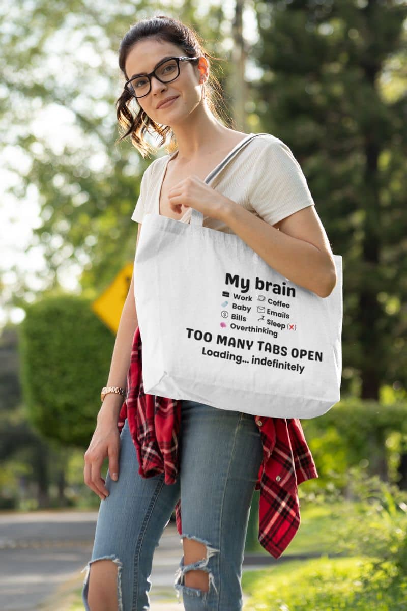 everyday carry tote with a woman carrying a tote bag with text 'My brain has too many tabs open. Loading… indefinitely.'