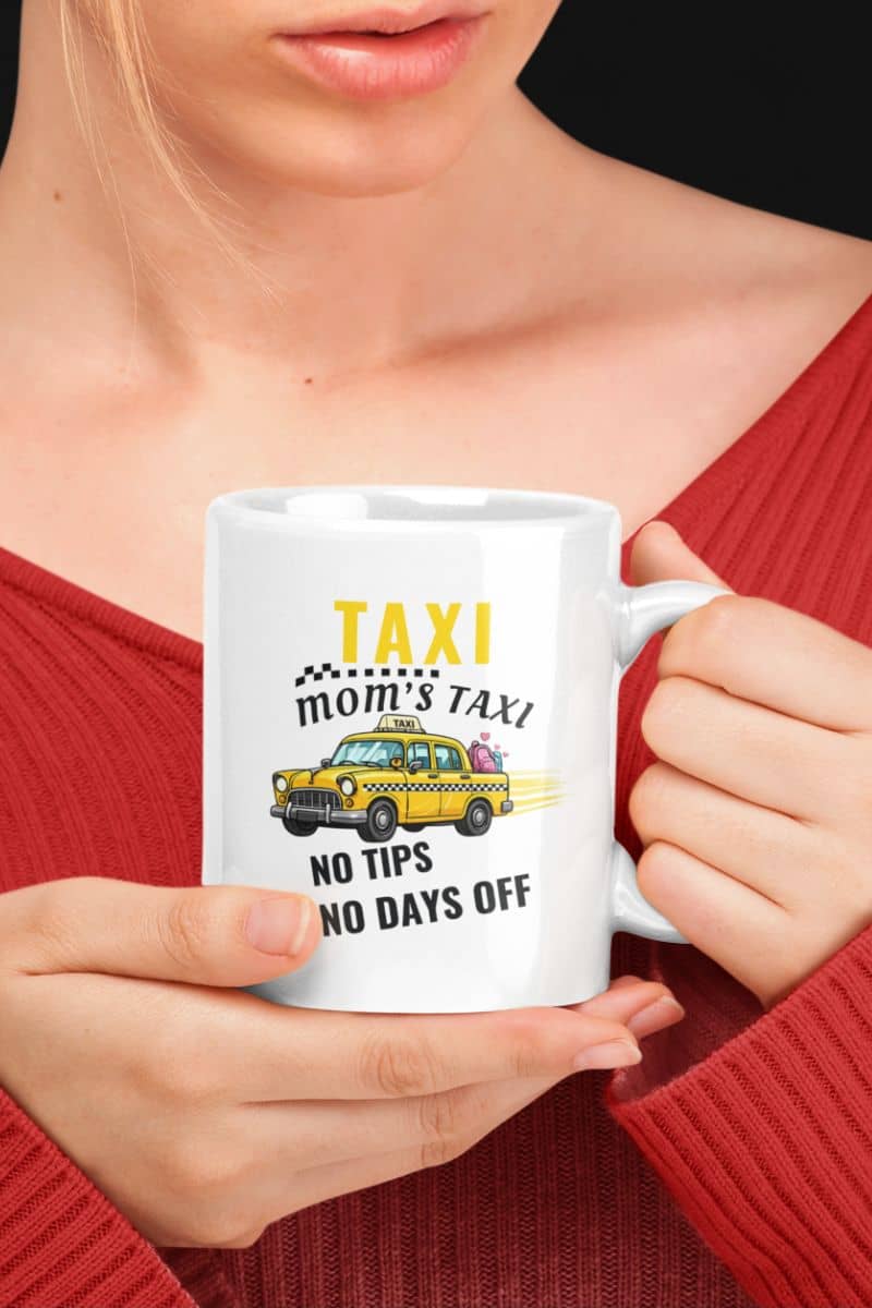 exhausted mom mug with a person holding a mug with a taxi-themed design and text 'Taxi, Mom’s Taxi – No tips, no days off'.