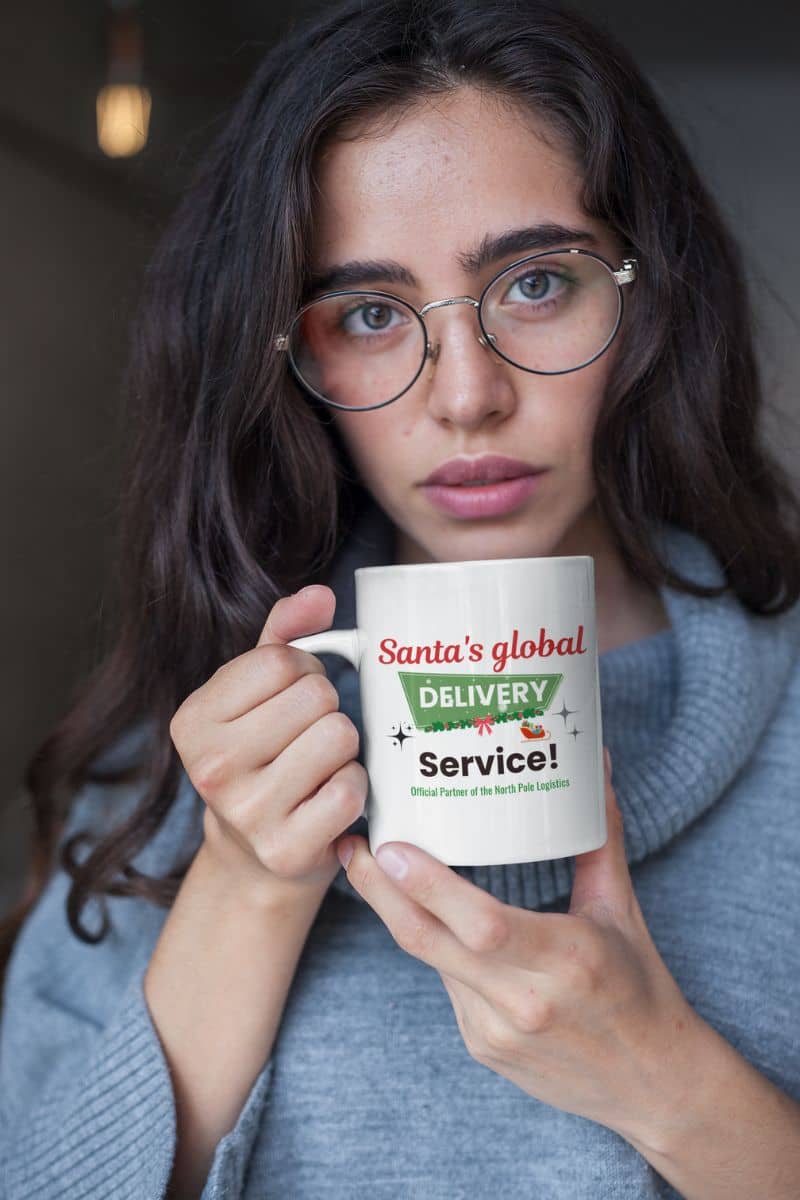 festive coffee cup with a person holding a mug with 'Santa's global delivery service' text