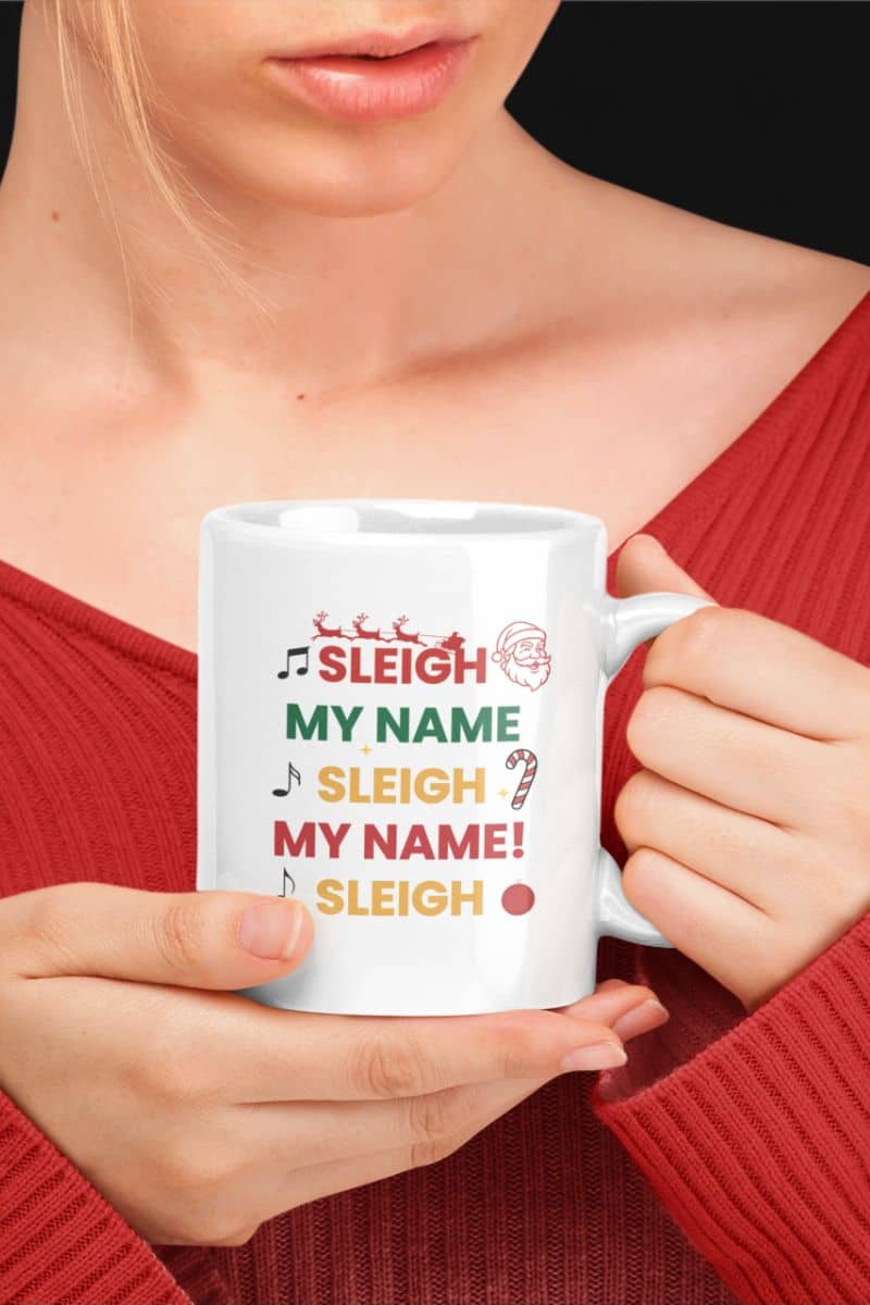 festive hot cocoa mug with a person holding a mug with text 'Sleigh My Name, Sleigh My Name' 