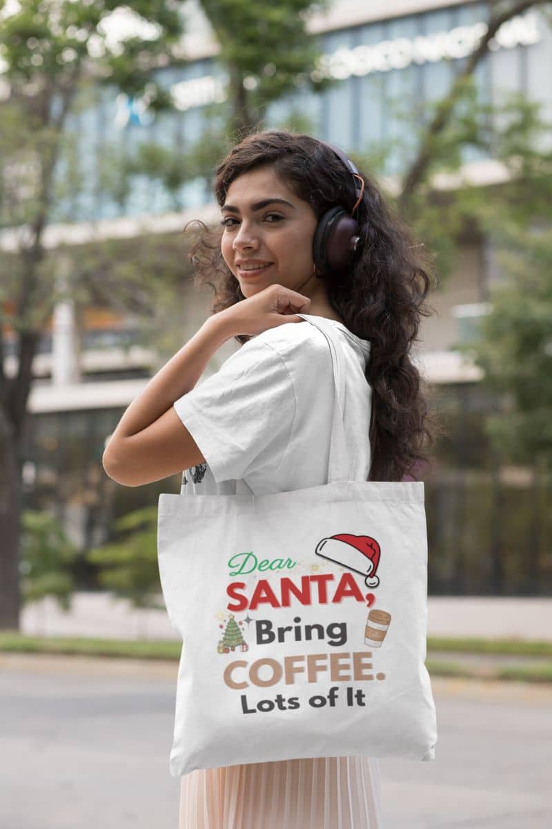 festive shopper tote with a woman holding a tote bag with text 'Dear Santa, Bring Coffee. Lots of It.' outdoors