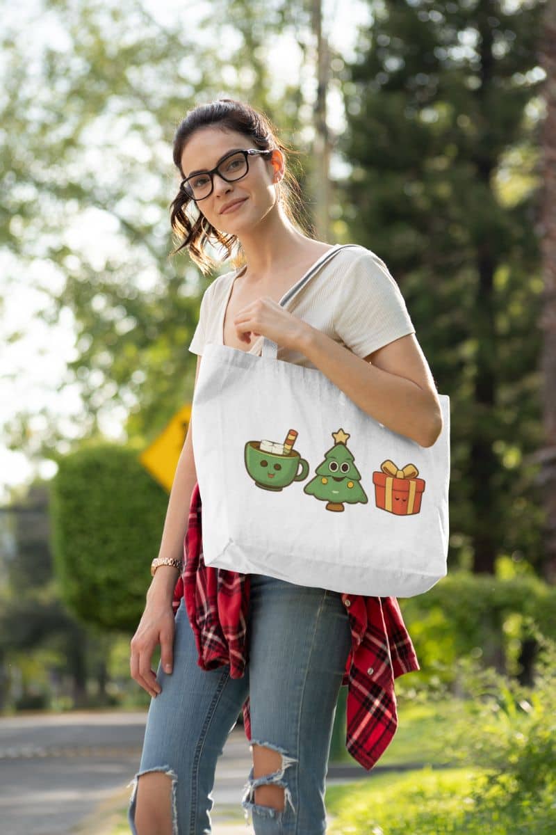 festive tote bag for women with a woman holding a tote bag with Christmas-themed designs outdoors.