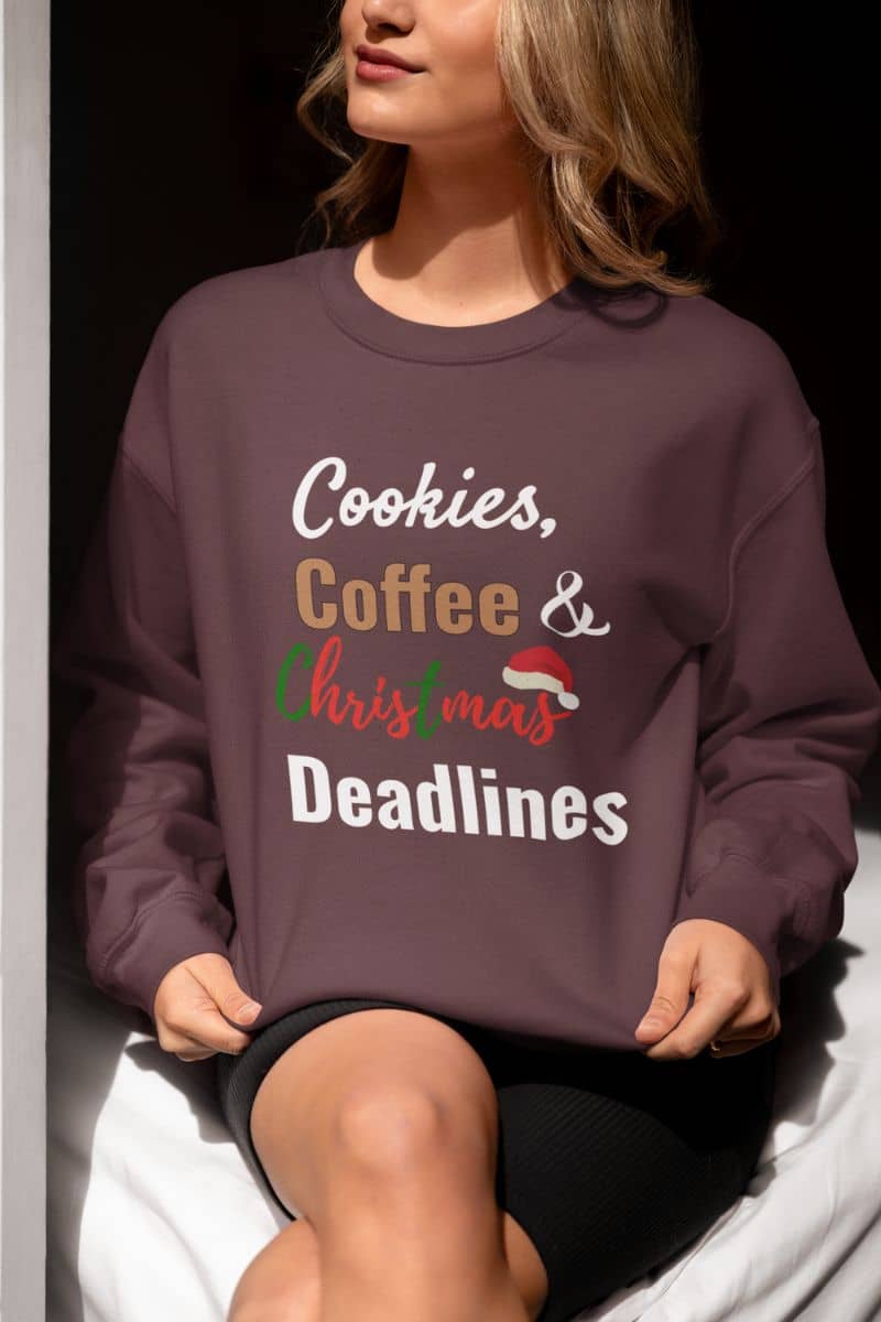 funny christmas sweatshirt with  a person wearing a sweatshirt with 'Cookies, Coffee & Christmas Deadlines' text.