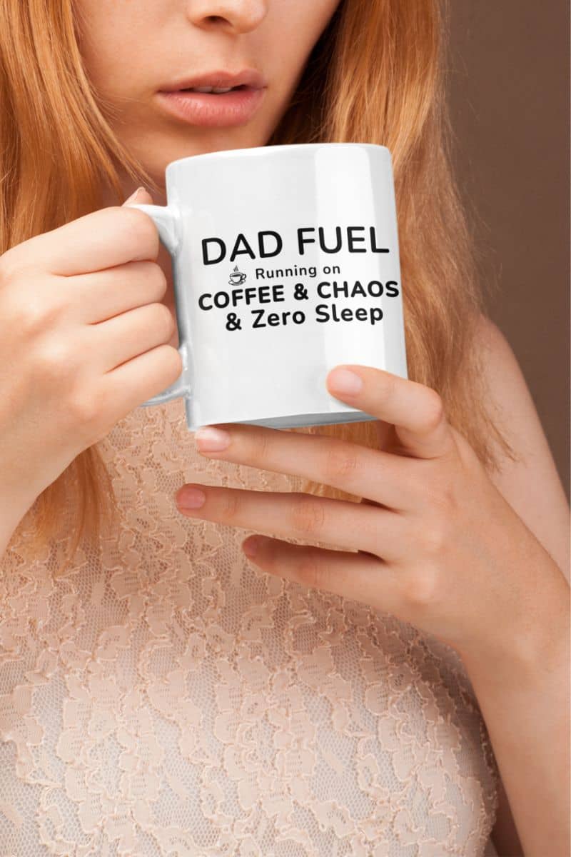 funny dad cups with a person holding a mug with text 'DAD FUEL Running on COFFEE & CHAOS & Zero Sleep' against a neutral background