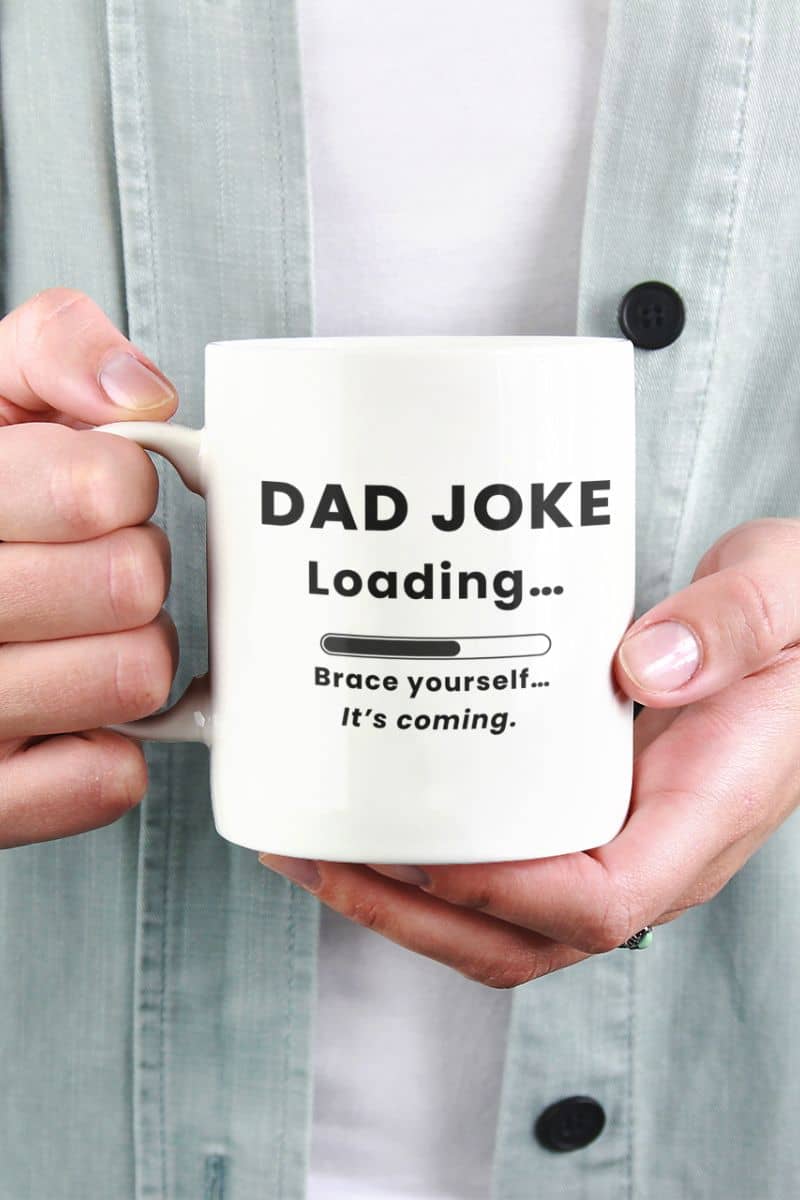 funny dad mug with a person holding a mug with 'Dad Joke Loading, Brace yourself…It’s coming.' text