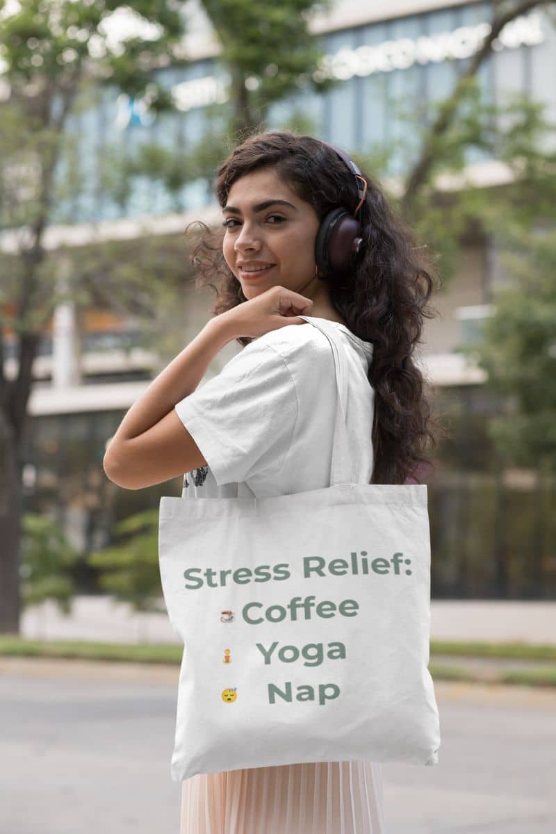 funny mindfulness tote with a woman wearing headphones and holding a tote bag with 'Stress Relief' text outdoors.