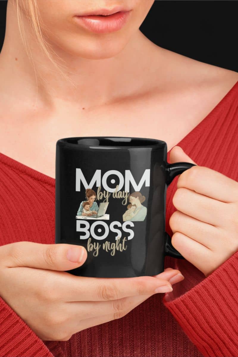 funny mom mug with a person holding a black mug with 'Mom by day, Boss by night' text and images.