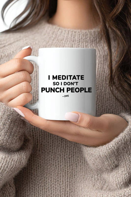 funny mugs for coworkers with a person holding a mug featuring the text 'I Meditate So I Don’t Punch People...yet'