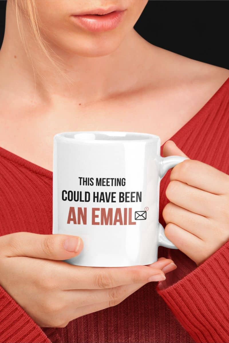 funny office coffee mug with a person holding a white mug with text 'THIS MEETING COULD HAVE BEEN AN EMAIL' in a red sweater.