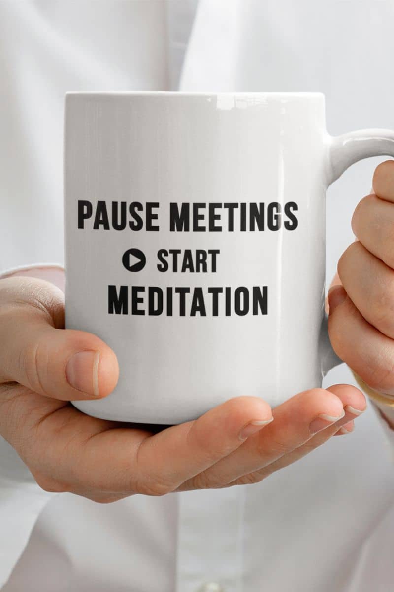 funny office mug with a person holding a mug featuring the text 'Pause Meetings, Start Meditation'