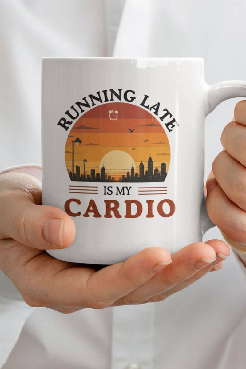 funny work mug with a white mug with 'Running late is my cardio' design held by hands against a white background