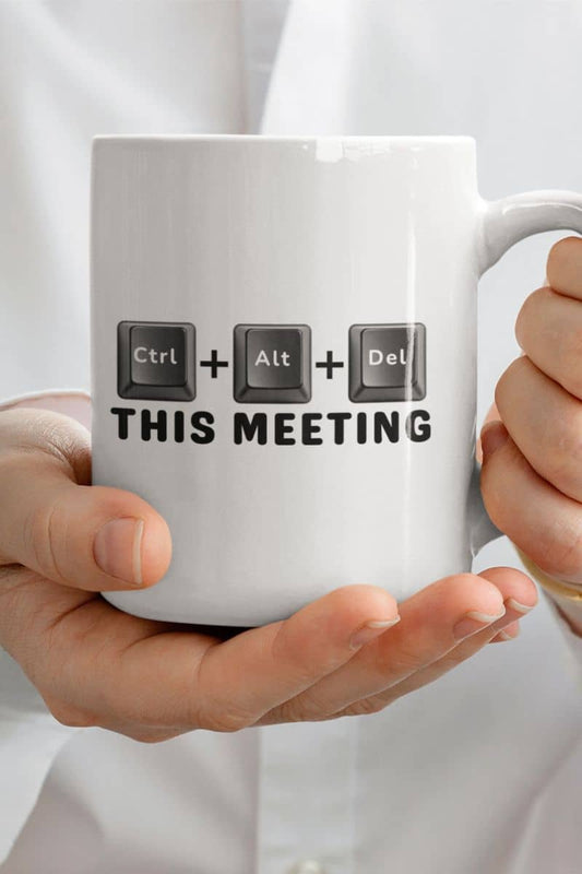 funny work mug with a white mug with computer keyboard key design and text 'Ctrl + Alt + Del This Meeting' held by a person