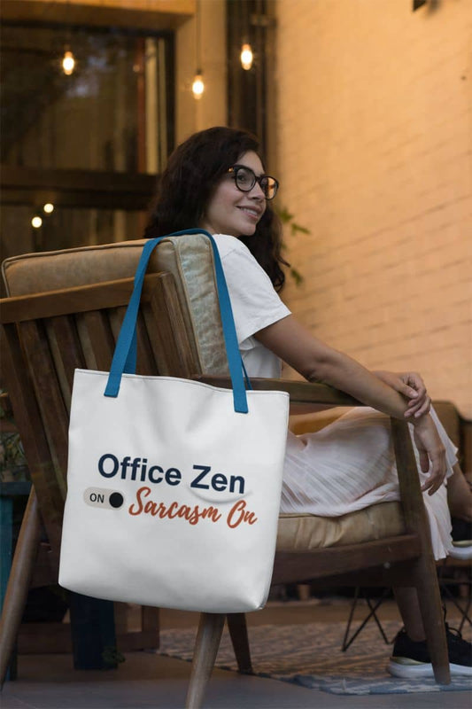 funny work tote bag with a woman sitting on a chair with a tote bag that says 'Office Zen On, Sarcasm On'.