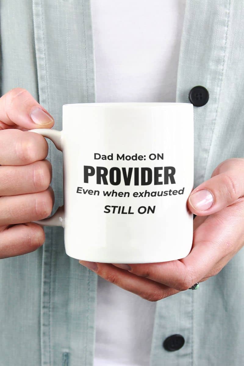 gift for dad who does everything with a person holding a mug featuring the text 'Dad Mode: On. Provider. Even when exhausted. Still on'