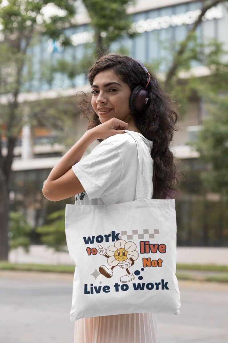 green lifestyle bag with a woman holding a tote bag with text 'Work to Live, Not Live to Work' outdoors