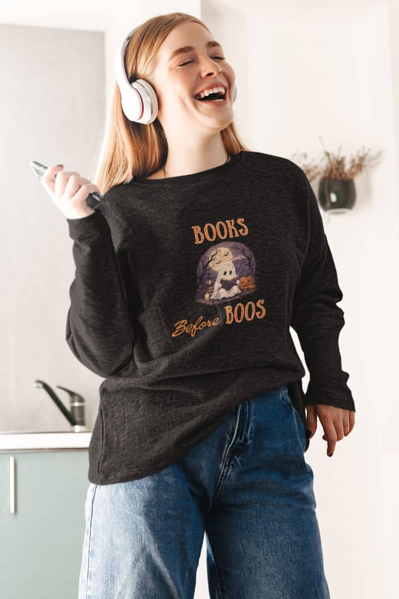 halloween ghost sweatshirt with a woman wearing a sweatshirt with text 'Books Before Boos'