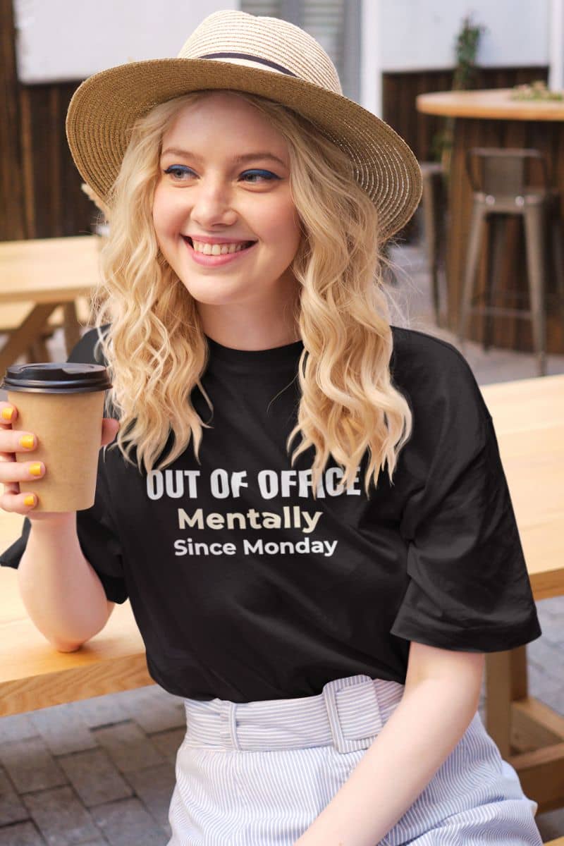 introvert office shirt with young girl wearing a t-shirt with text 'Out of Office. Mentally Since Monday., holding a cup of coffee