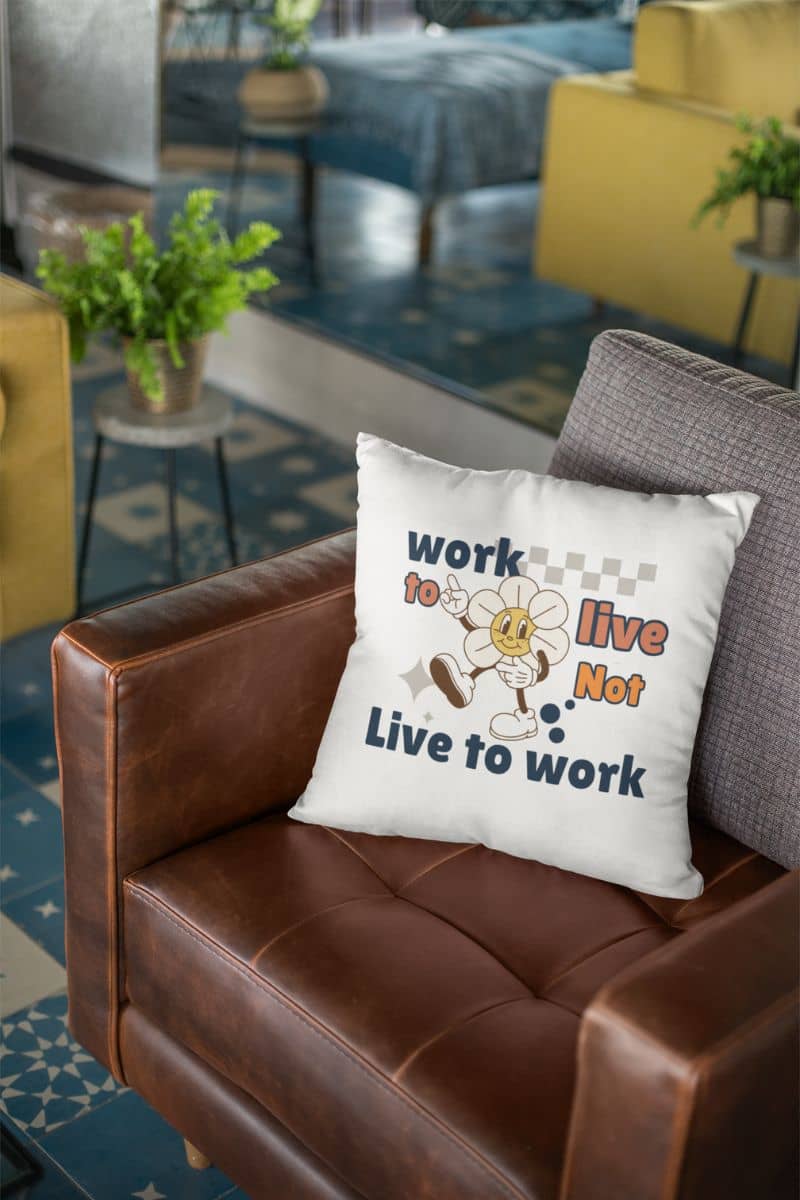 living room decor pillow with a decorative pillow with the quote 'Work to Live, Not Live to Work' on a brown couch in a living room setting.
