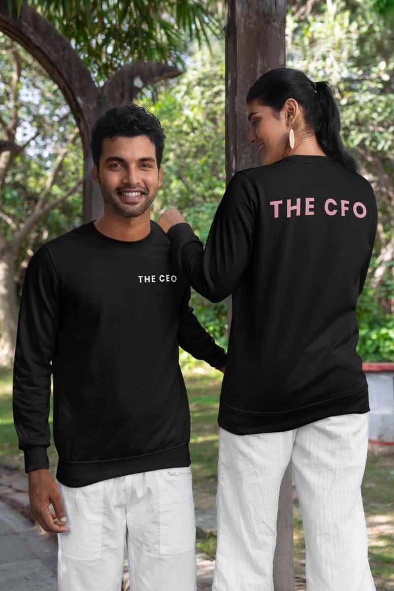 matching couple sweatshirts with two people wearing black sweatshirts with 'THE CEO' and 'THE CFO' text, standing outdoors.