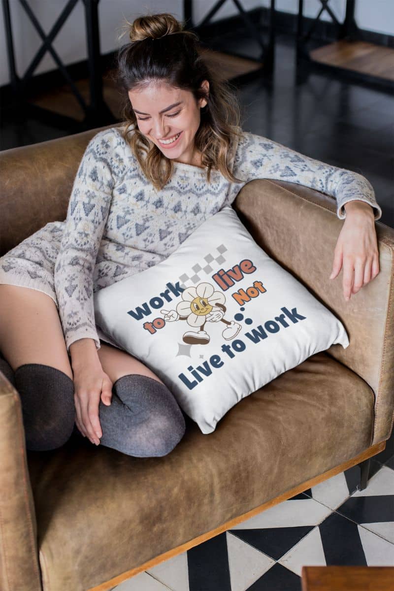 mindful decor cushion with a woman sitting on a couch with a pillow featuring text 'Work to Live, Not Live to Work'.
