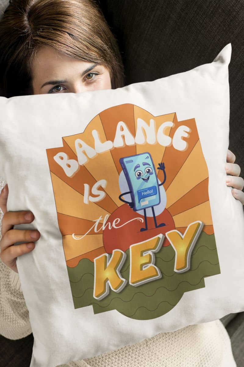 mindful living pillow with a person holding a pillow with 'Balance is the Key' design featuring a cartoon character.