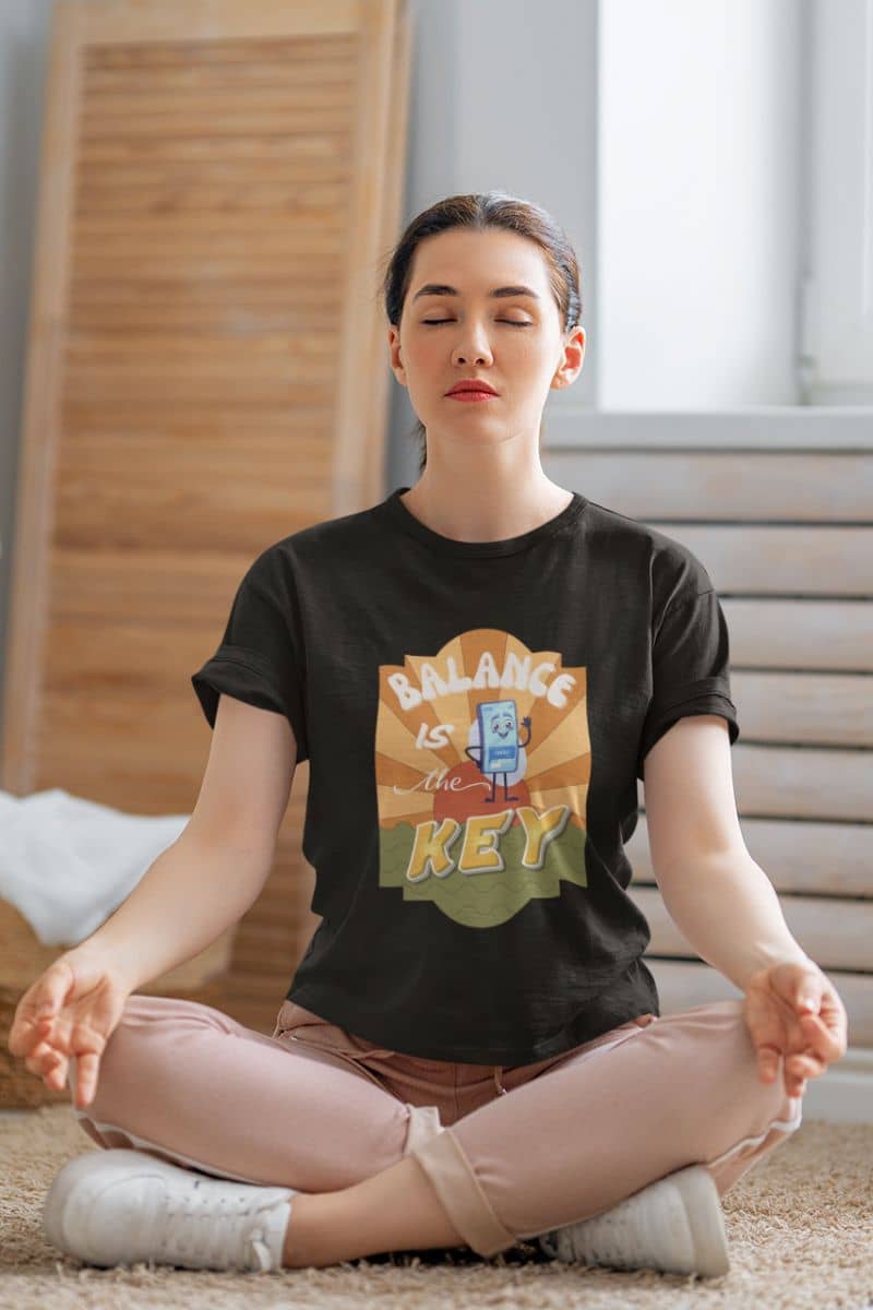 mindfulness t-shirt with a person meditating wearing a t-shirt with 'Balance is the Key' design.
