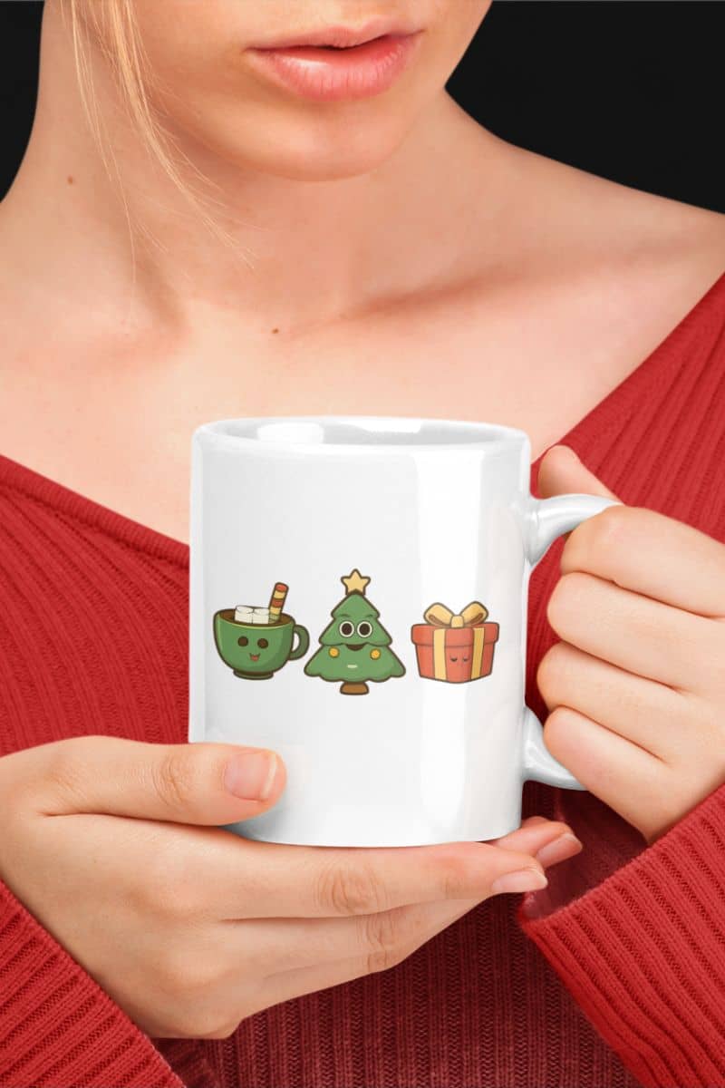 minimalist christmas mug with a person holding a white mug with Christmas-themed illustrations, wearing a red top.