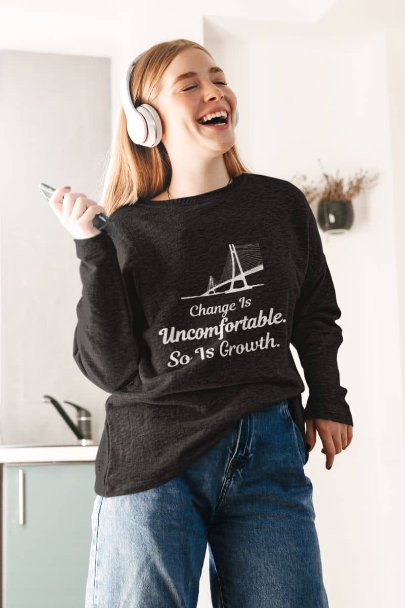 minimalist motivational sweatshirt with a person wearing a sweatshirt with a motivational quote, standing in a kitchen.