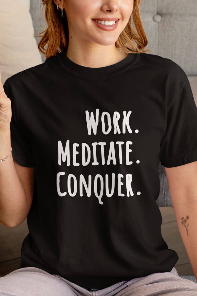 minimalist workwear shirt with a person wearing a black t-shirt with 'Work. Meditate. Conquer.' text.
