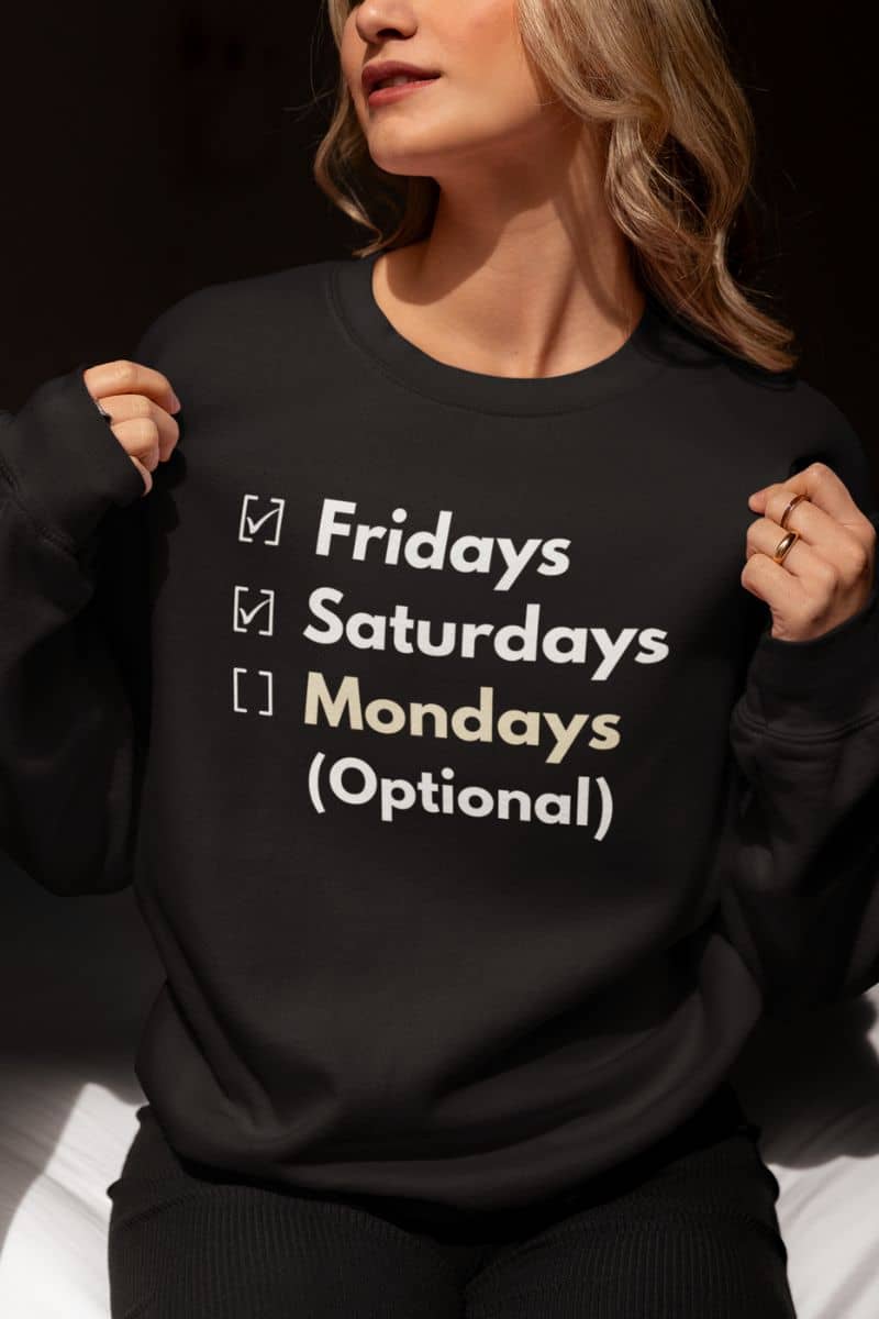 monday humor sweatshirt with a person wearing a black sweatshirt with text 'Fridays and Saturdays, Mondays (Optional)'