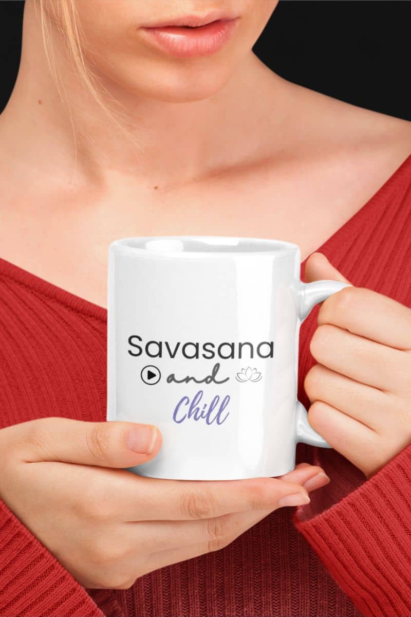 morning mindfulness mug with a person holding a white mug with 'Savasana and Chill' text, wearing a red top.