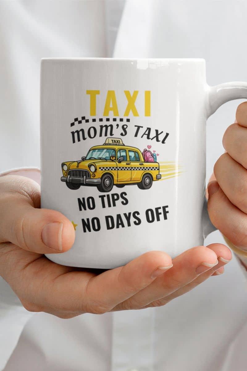 motherhood humor mug with a white mug with a taxi-themed design held by hands against a white background