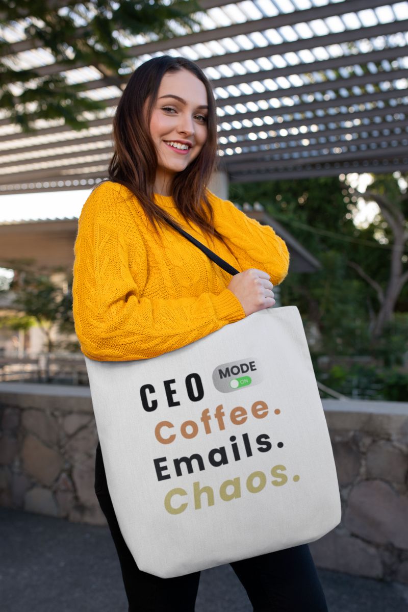 motivational office bag featuring a girl holding a tote bag with text 'CEO Mode: Coffee. Emails. Chaos.', outdoors