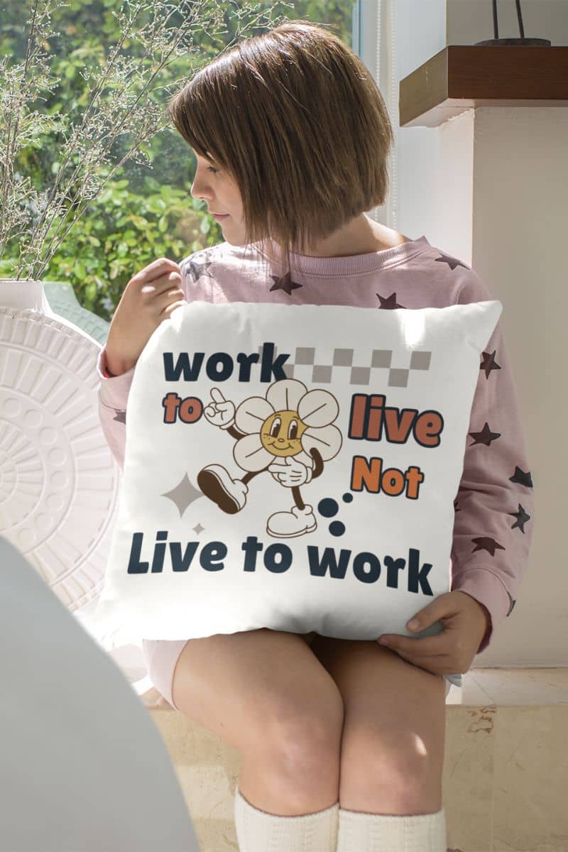 motivational throw pillow with a person holding a pillow with a motivational quote 'Work to Live, Not Live to Work' and cartoon character.