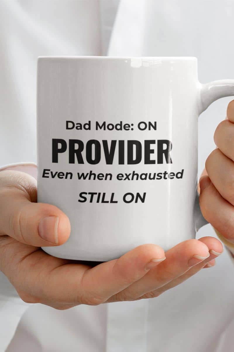 mugs for dad from daughter with a white mug with text 'Dad Mode: On. Provider. Even when exhausted. Still on' held by a person, on a plain background